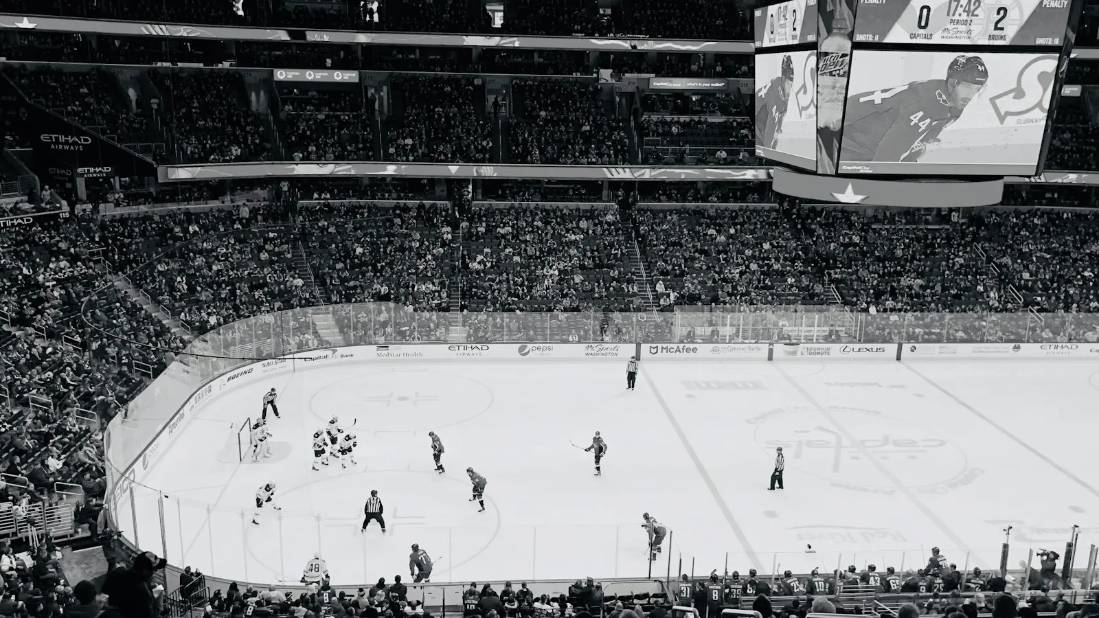 Black and white view of a hockey arena from the upper level