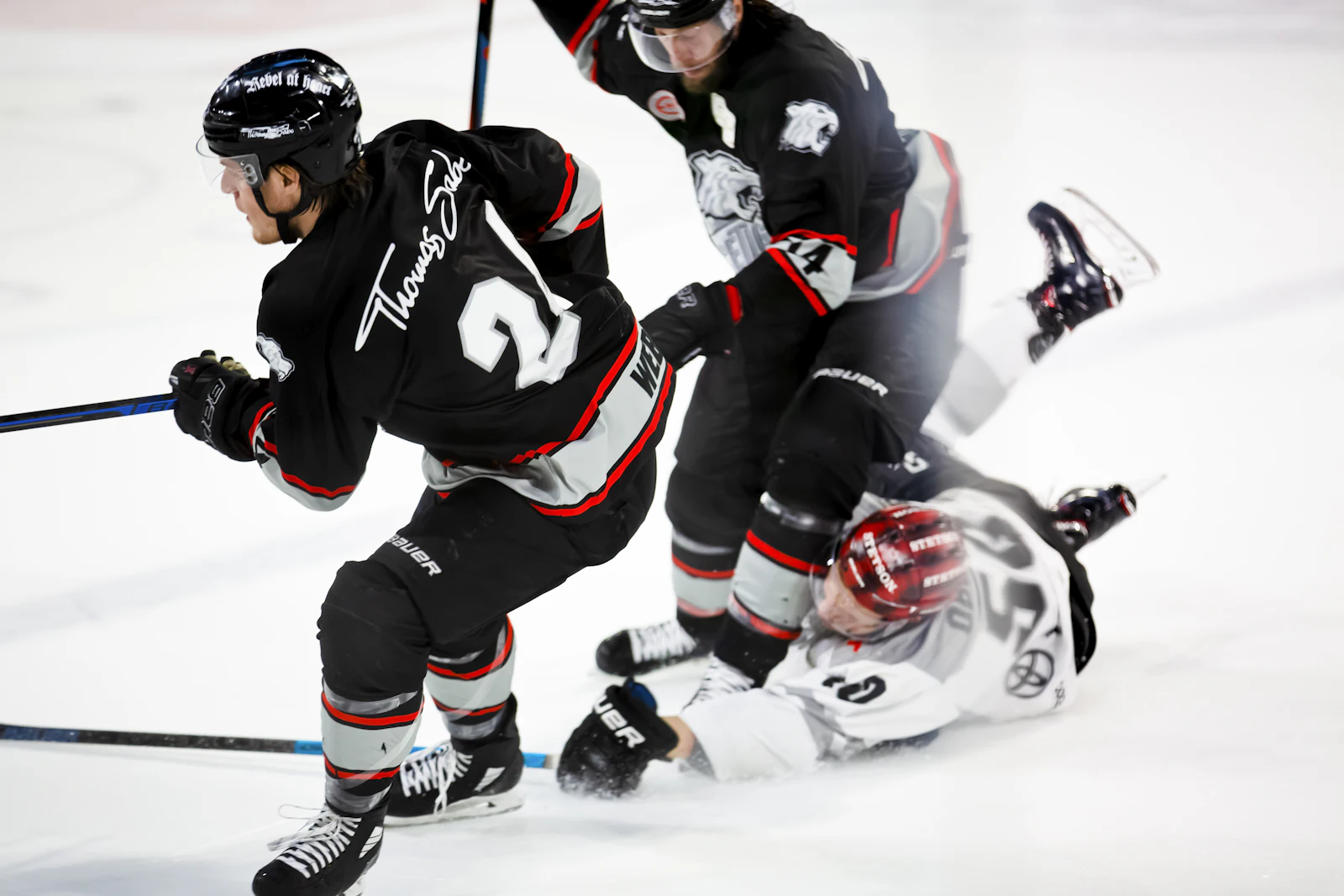 Hockey players colliding in front of the net, the kind of play that can lead to hockey penalties