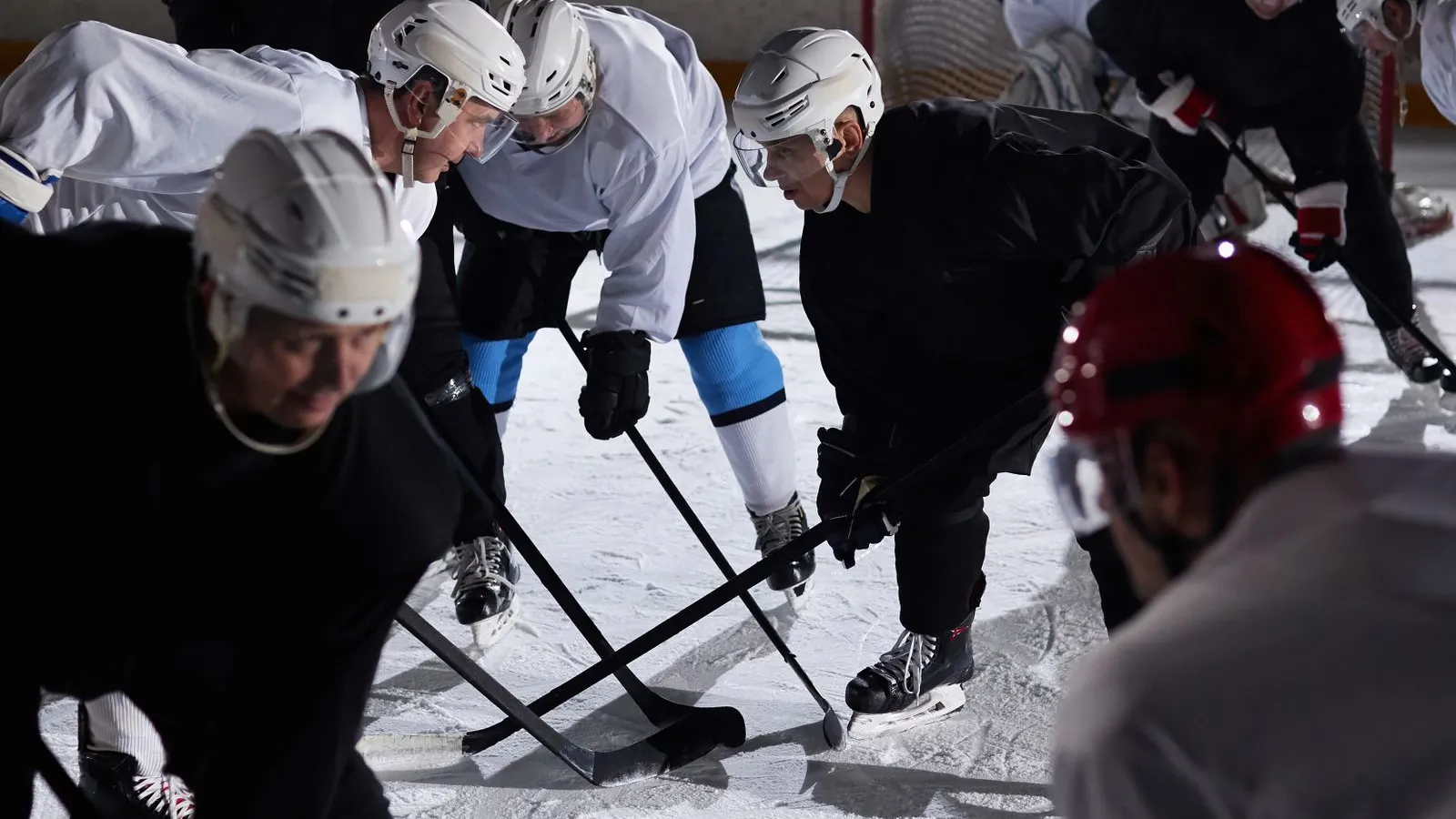 Hockey players running a drill during team practice