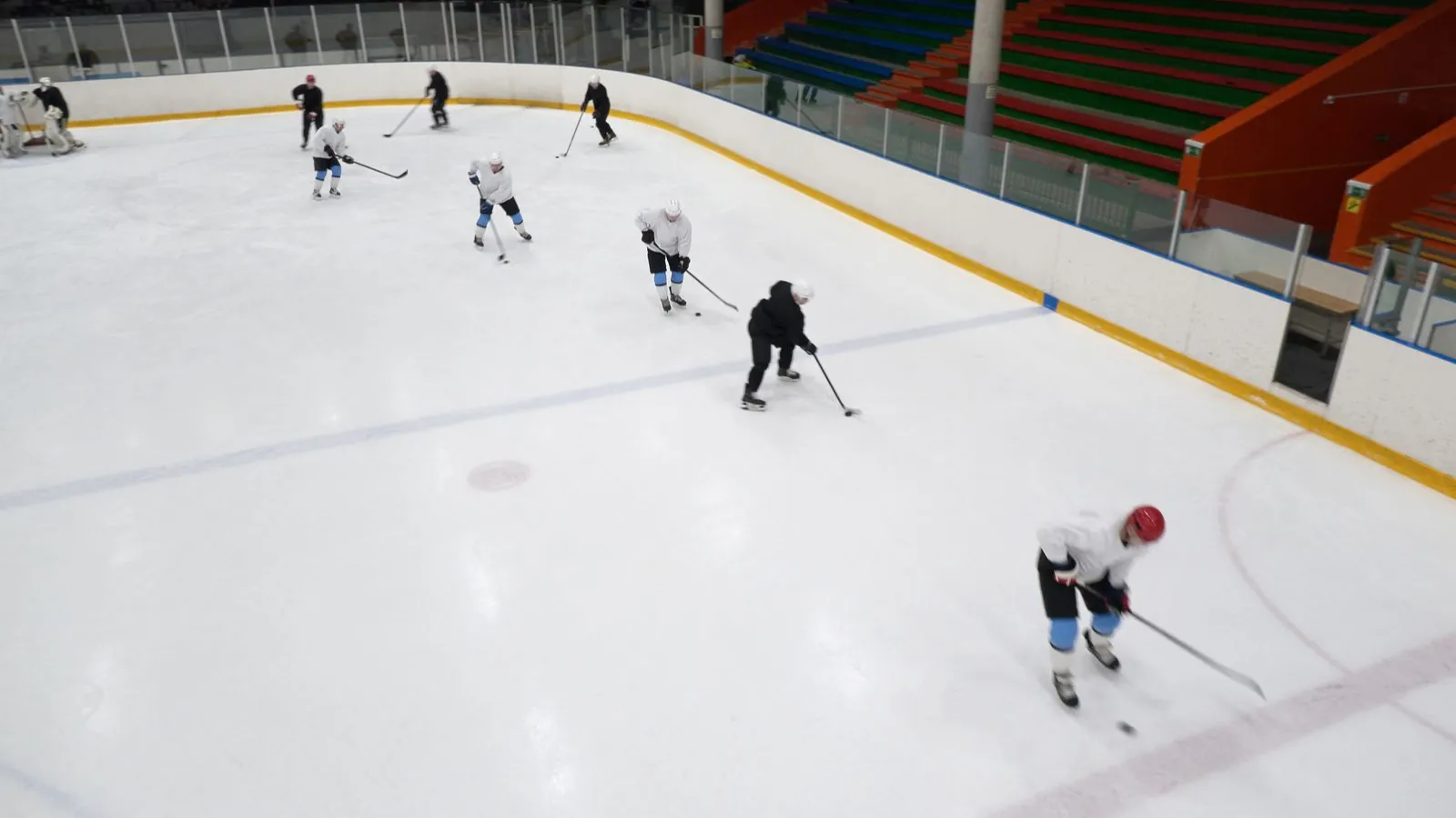 Hockey players practicing on an indoor rink