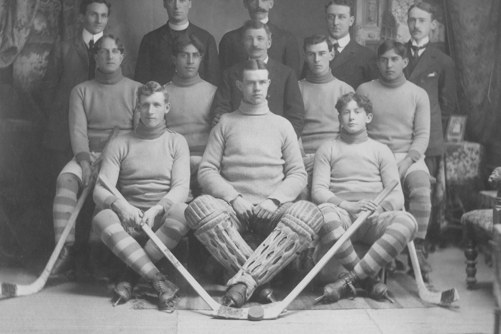 Vintage black-and-white hockey team portrait, evoking Tulsa's Adams Cup champions of the past