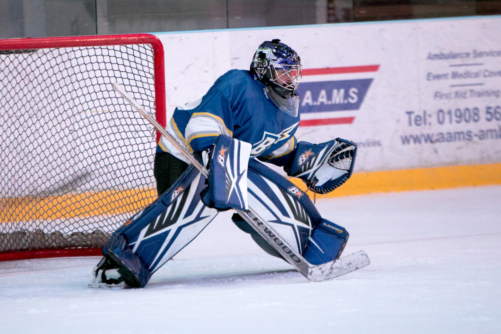 Young hockey goalie setting up for a save, illustrating Tulsa Oilers Foundation youth hockey programs